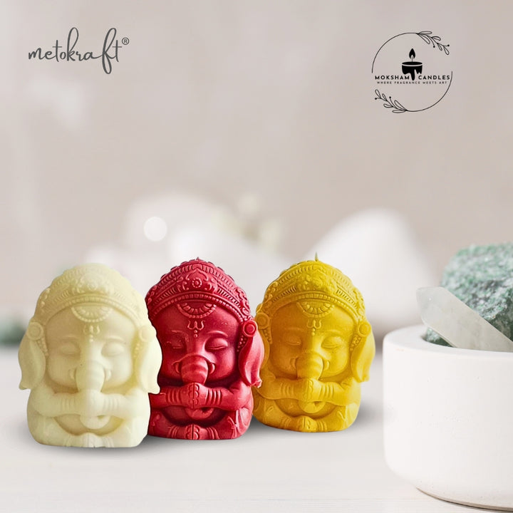 Moksham 'Lord Ganesha' Meditational Aromatherapy Candle, Set of 3 pcs (Off White, Red & Yellow)